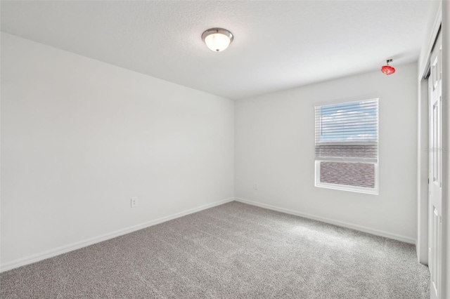 spare room with carpet flooring and baseboards