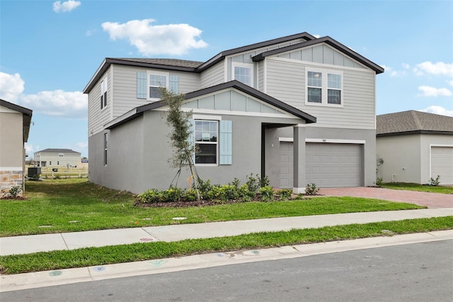 view of front of property with decorative driveway, board and batten siding, a front yard, a garage, and cooling unit