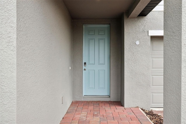 property entrance with stucco siding