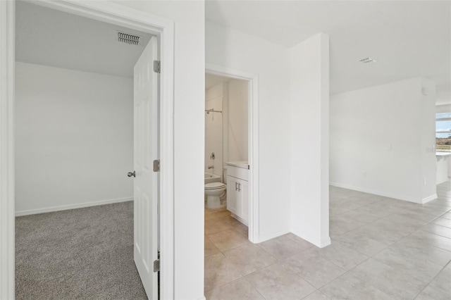 bathroom featuring shower / bathtub combination, tile patterned flooring, toilet, visible vents, and baseboards