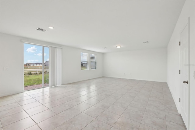 empty room with visible vents and light tile patterned flooring