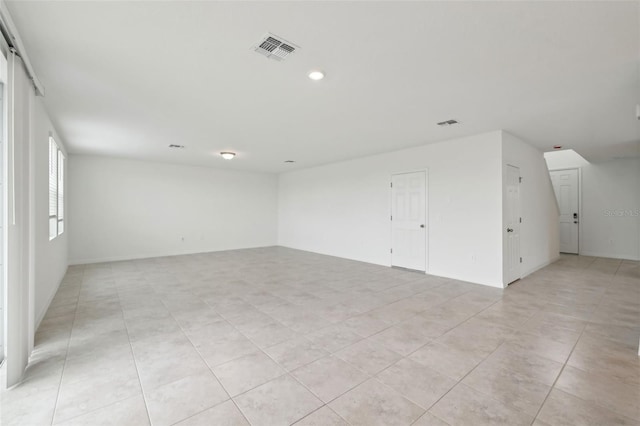 spare room with visible vents and light tile patterned flooring