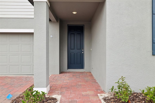 entrance to property with stucco siding