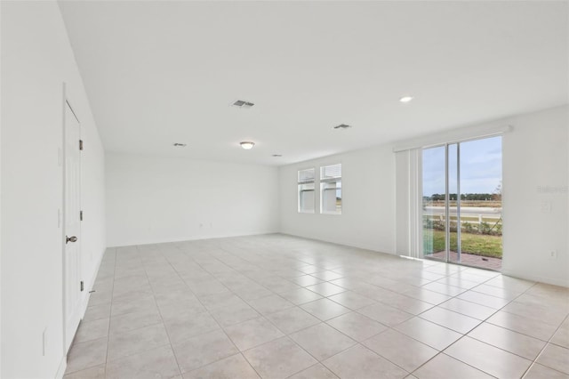 spare room with light tile patterned floors and visible vents