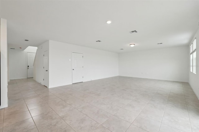 empty room featuring light tile patterned floors and visible vents