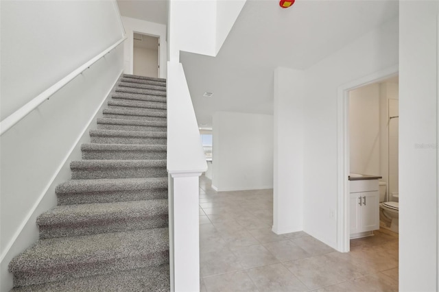 stairway featuring tile patterned floors