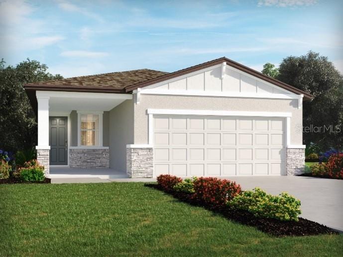 view of front of home with a garage and a front lawn