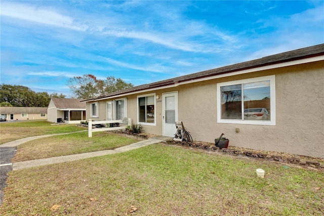 ranch-style home featuring a front yard