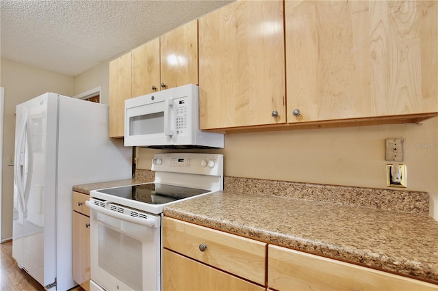 kitchen featuring white appliances, light brown cabinetry, light hardwood / wood-style floors, and a textured ceiling