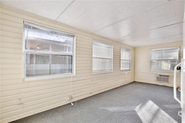 unfurnished sunroom with a wall unit AC