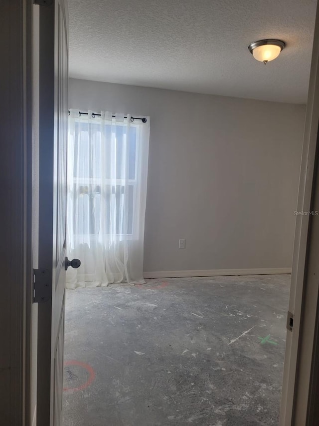 spare room with a textured ceiling