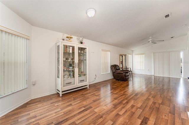 unfurnished room featuring ceiling fan, vaulted ceiling, and wood-type flooring