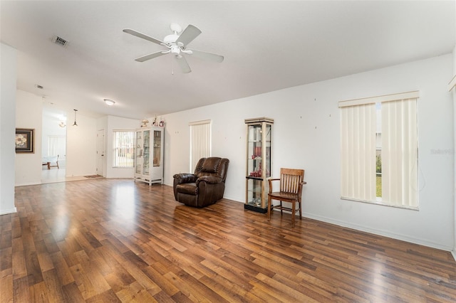 sitting room with lofted ceiling, dark hardwood / wood-style floors, and ceiling fan