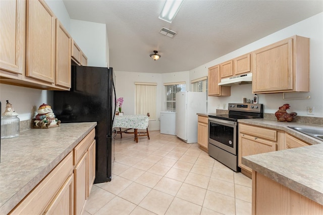 kitchen with black refrigerator, light brown cabinetry, white refrigerator, light tile patterned floors, and electric stove