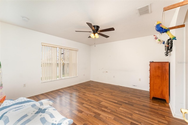 unfurnished bedroom featuring dark wood-type flooring and ceiling fan