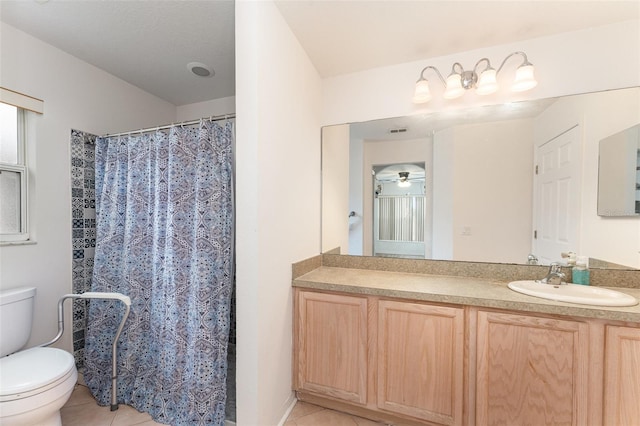 bathroom featuring vanity, curtained shower, tile patterned floors, and toilet