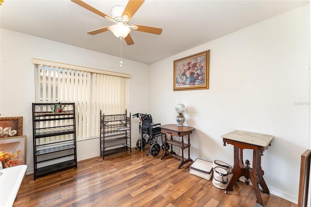 miscellaneous room with ceiling fan and dark hardwood / wood-style flooring