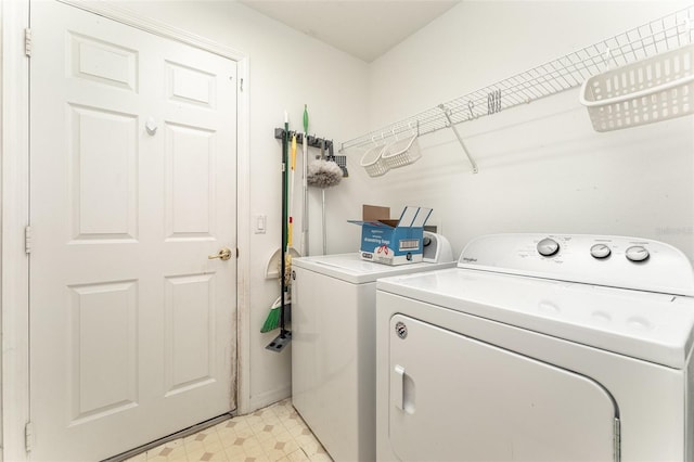 laundry room with washing machine and clothes dryer