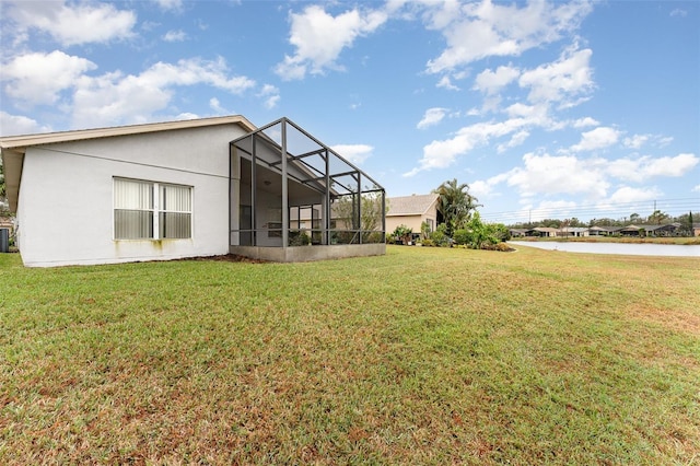 back of house featuring a yard, cooling unit, and glass enclosure