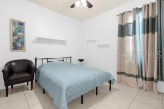 bedroom with light tile patterned floors and ceiling fan