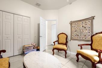 sitting room featuring tile patterned flooring, visible vents, and baseboards