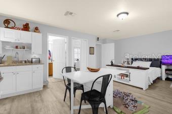 dining room featuring visible vents and light wood-style flooring