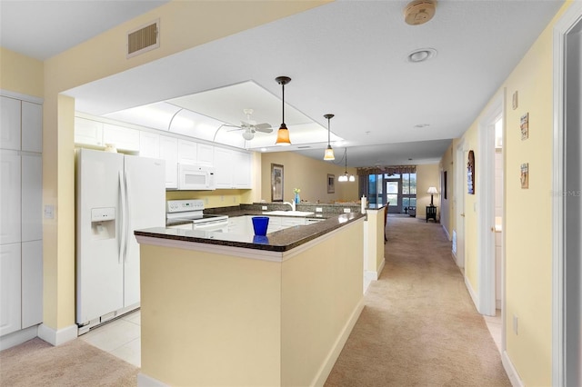 kitchen with pendant lighting, light colored carpet, white appliances, and white cabinets