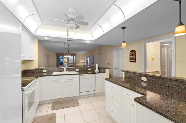 kitchen with white cabinetry, sink, hanging light fixtures, and white appliances