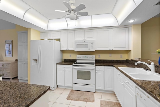 kitchen with light tile patterned floors, sink, white appliances, and white cabinetry