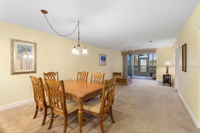 carpeted dining space featuring ceiling fan