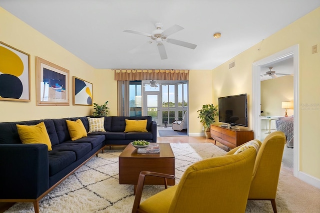 carpeted living room with ceiling fan