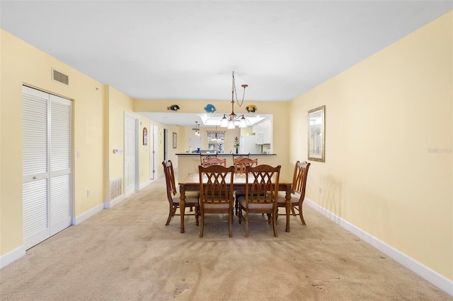 dining area featuring light colored carpet