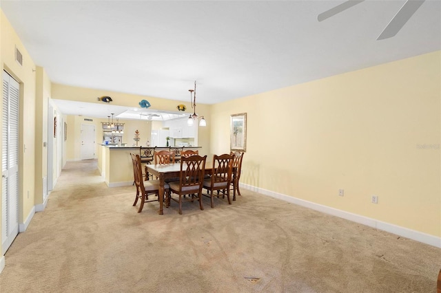 dining room with light colored carpet