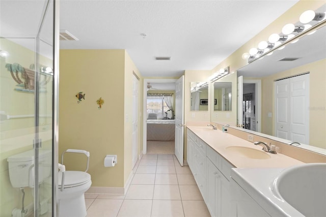 bathroom featuring a textured ceiling, an enclosed shower, tile patterned floors, vanity, and toilet