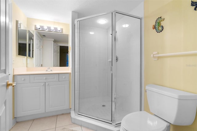 bathroom featuring toilet, a shower with door, tile patterned floors, a textured ceiling, and vanity