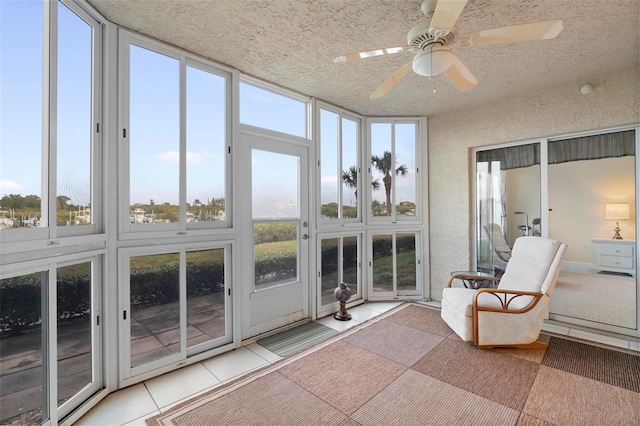 sunroom / solarium featuring ceiling fan