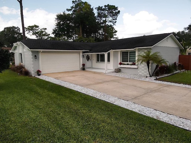 ranch-style house with a garage and a front lawn