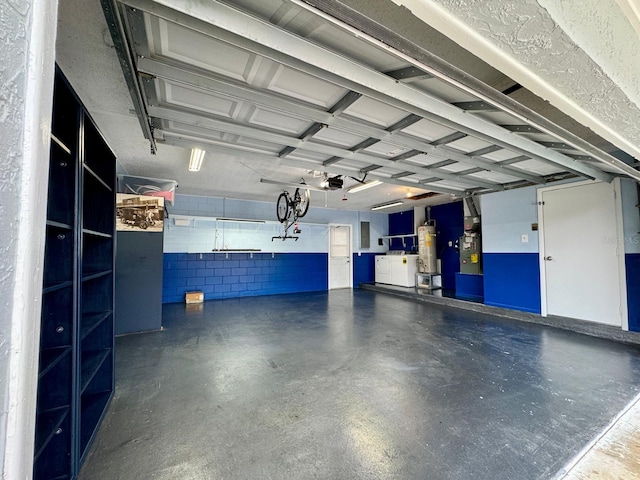 garage with water heater and a garage door opener