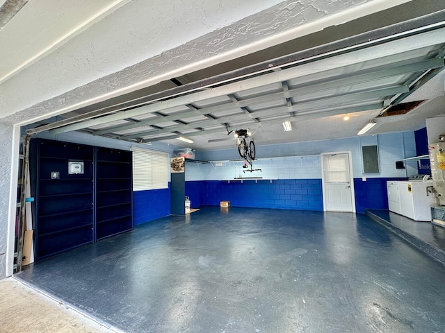 garage featuring washer and clothes dryer and electric panel