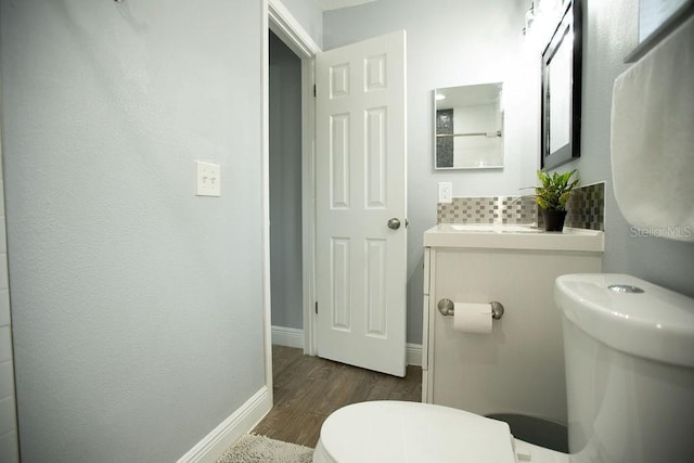 bathroom featuring sink, hardwood / wood-style floors, and toilet