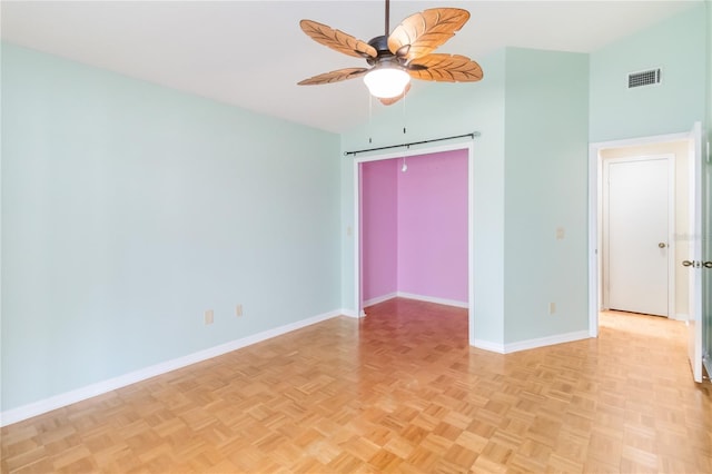 unfurnished room with light parquet flooring and ceiling fan