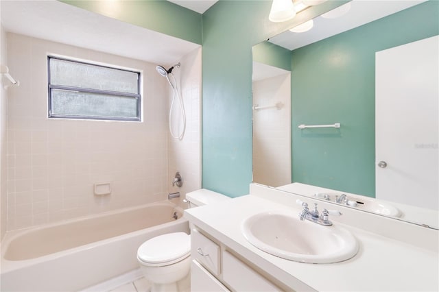 full bathroom featuring tiled shower / bath, vanity, and toilet