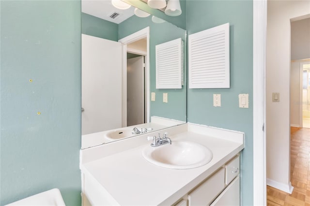 bathroom with vanity and parquet floors