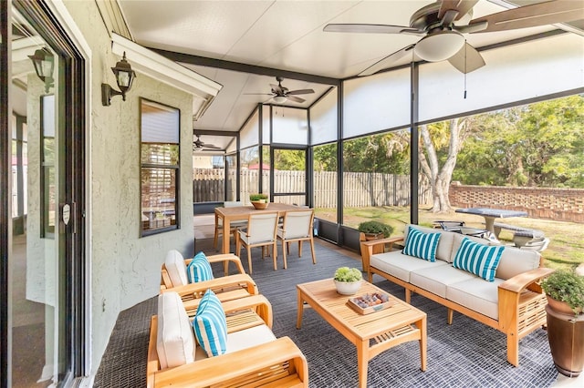 sunroom / solarium featuring ceiling fan