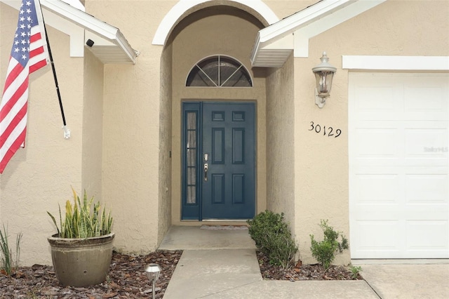 view of exterior entry featuring a garage