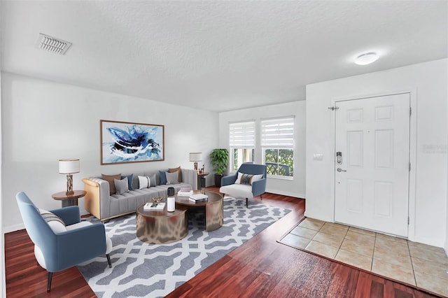 living room with hardwood / wood-style floors and a textured ceiling