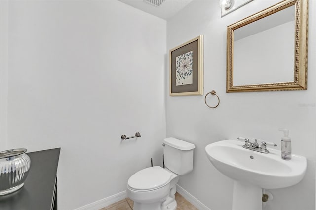 bathroom with sink, tile patterned floors, and toilet