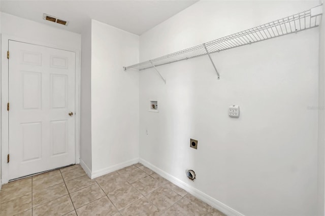 clothes washing area with washer hookup, light tile patterned floors, and hookup for an electric dryer