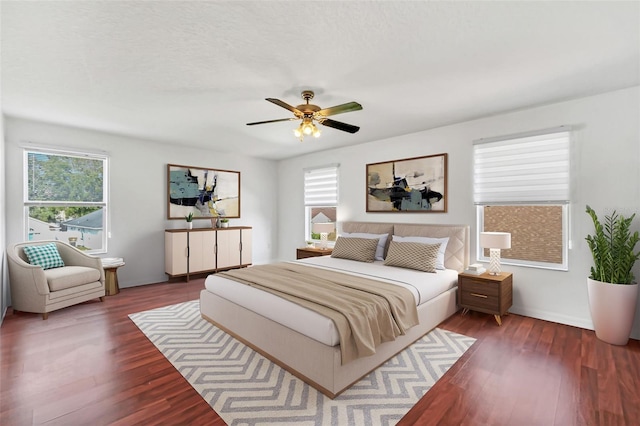 bedroom with ceiling fan and dark wood-type flooring