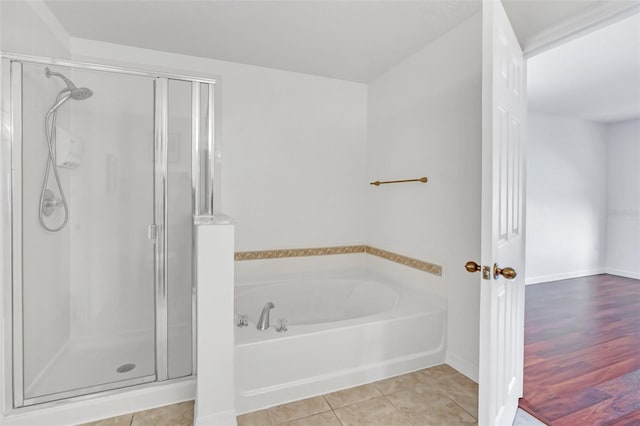 bathroom with independent shower and bath and tile patterned flooring